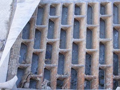 a sewer grate purposefully obfusctad by a sheet of plastic, but this time taken without flash