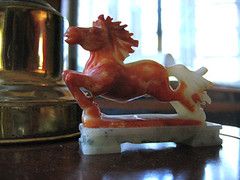 a red, soapstone horse in full gallop