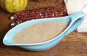 gravy in a baby blue gravy boat; there is an ear of glass gem corn and a gourd in the image as well