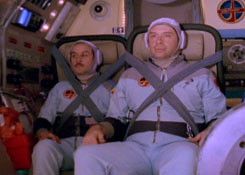 a still from the film Interkosmos showing two men strapped into a rocket