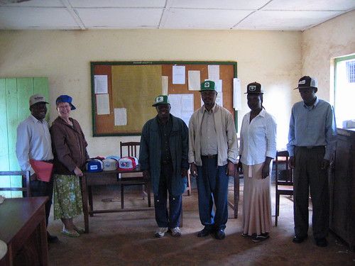 six people in a classroom and many several seed caps