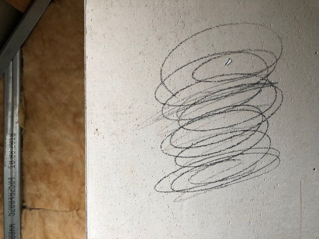 a tornado drawn in pencil on a concrete pillar in front of fiberglass insulation