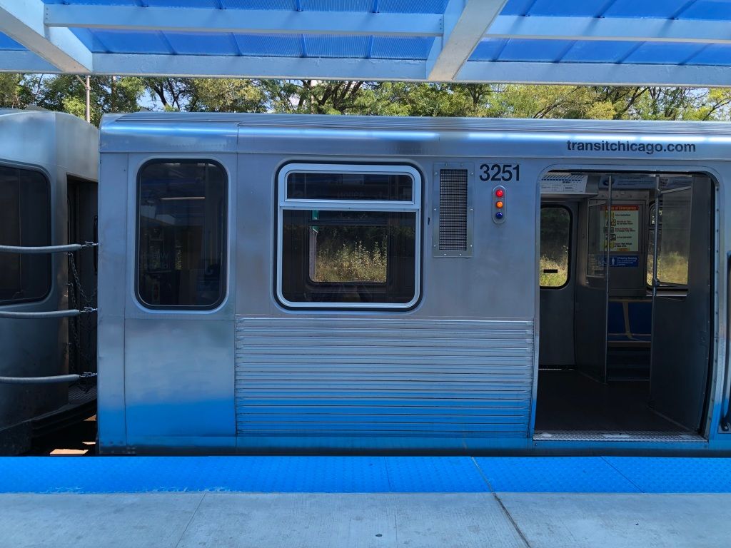 a very blue photo of part of a car on the Blue Line in the Chicago El