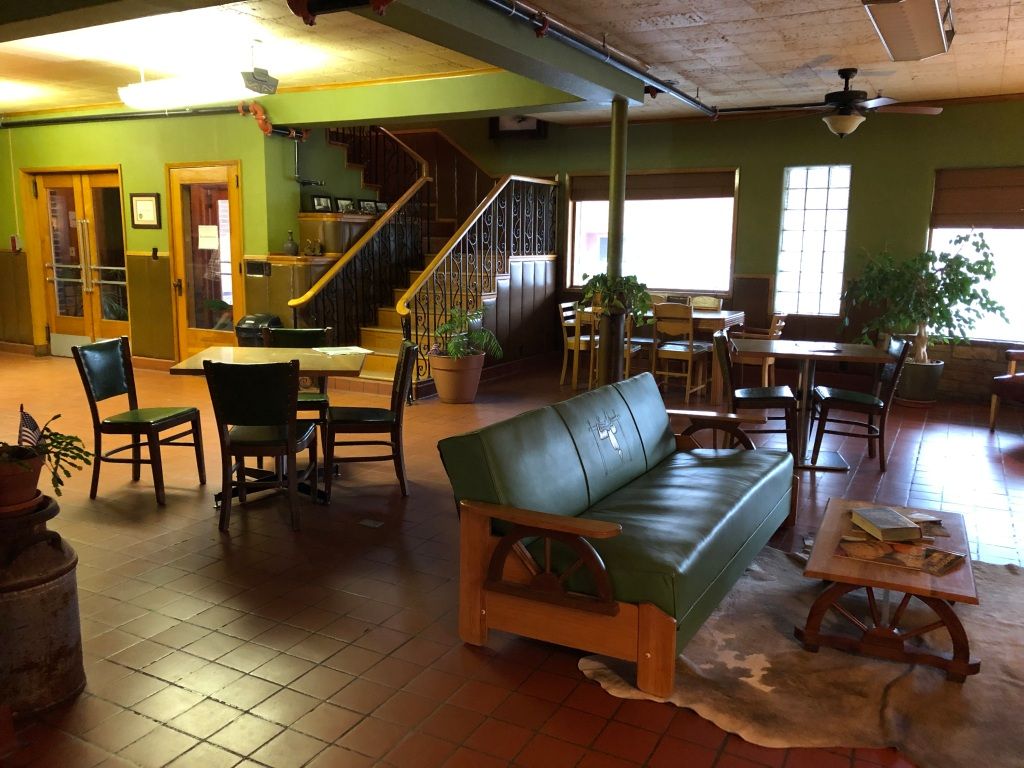 the vintage green and brown interior of the lobby of the Bassett Lodge
